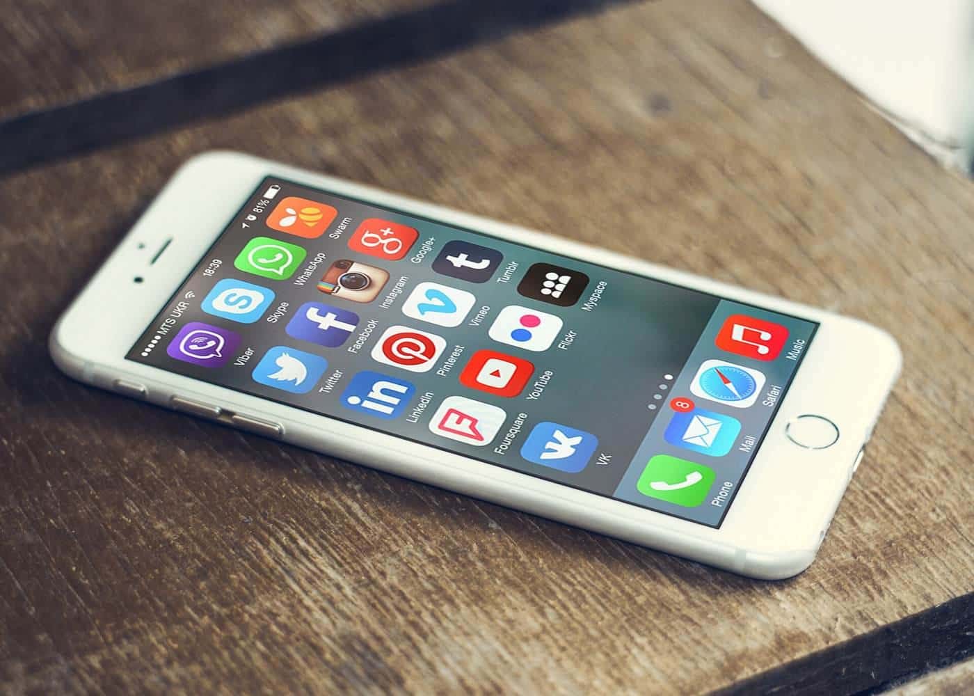 Social media app icons on the screen of a smartphone